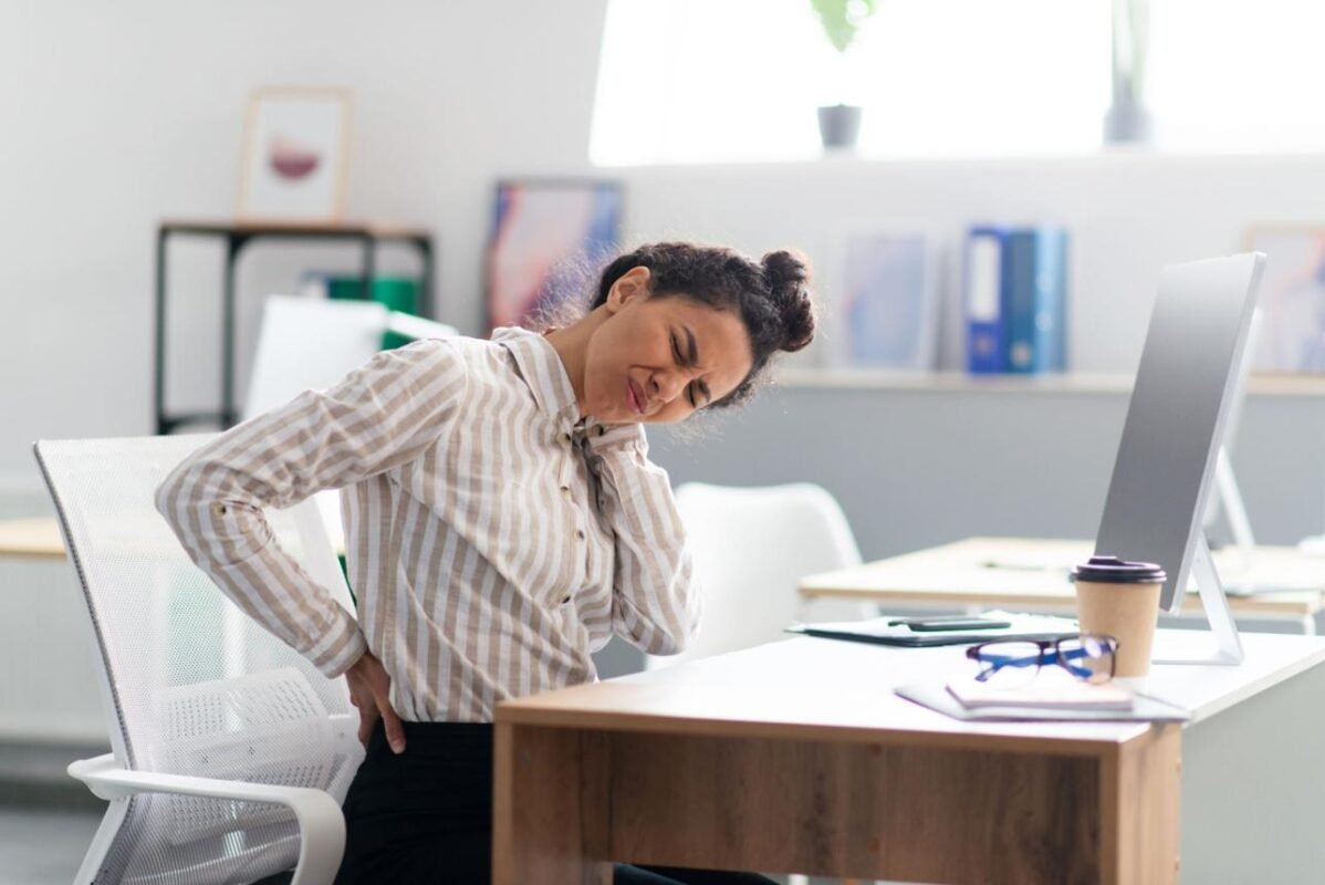 Professional experiencing back pain before using a massage chair